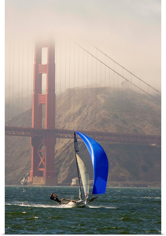 A Skiff sails in the San Francisco Bay near the Golden Gate Bridge