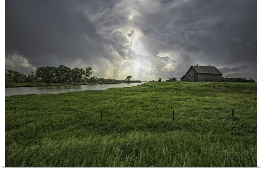 Abandoned barn with storm clouds converging overhead, Nebraska, united states of America.