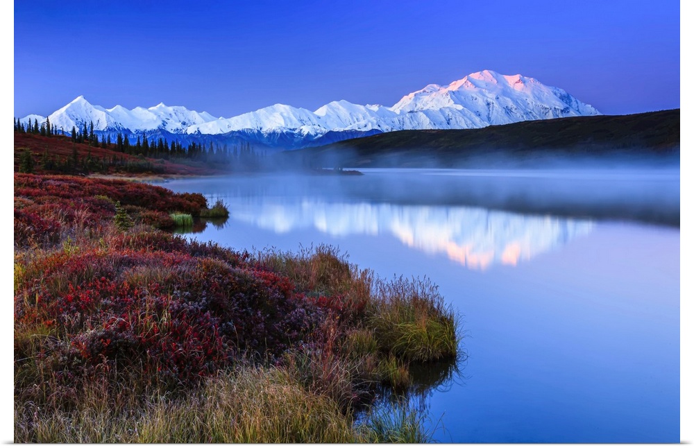 Reflection of the Alaska Range mountains in the tranquil water of Wonder Lake at sunrise in Denali National Park and Prese...