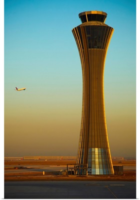 An Airplane Flies Past The Air Traffic Control Tower At The Beijing Airport, China