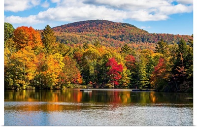 Autumn coloured trees in a forest around a small lake, Sally's Pond, Quebec, Canada