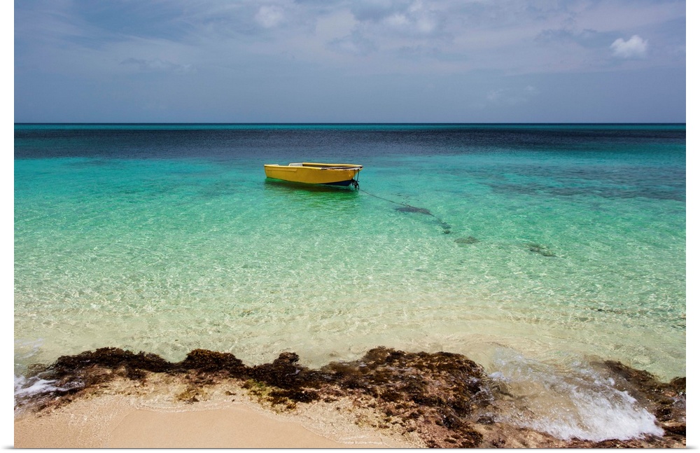 A lone boat in the turquoise water off a tropical island, Frederiksted, St. Croix, Virgin Islands, United States of America.