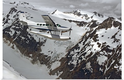 Cessna Caravan Amphibian Seaplane Flying Through Coast Mountains, British Columbia