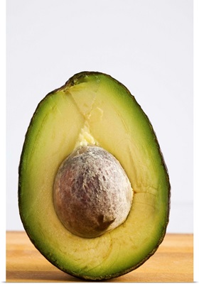 Close Up Of An Avocado Standing Upright Cut In Half With The Pit