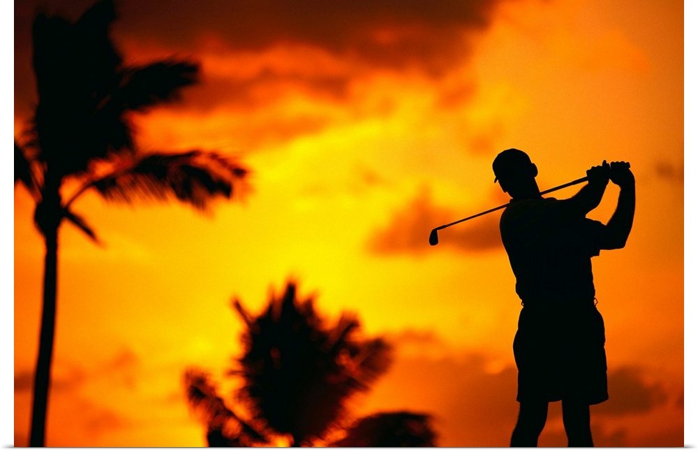 Close-Up Of Man Swinging, Silhouetted In Orange Skies, Palms Hazy In Background