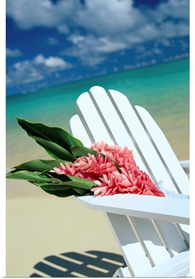 Close-Up Of White Beach Chair With Bunch Of Pink Ginger, On White Sand