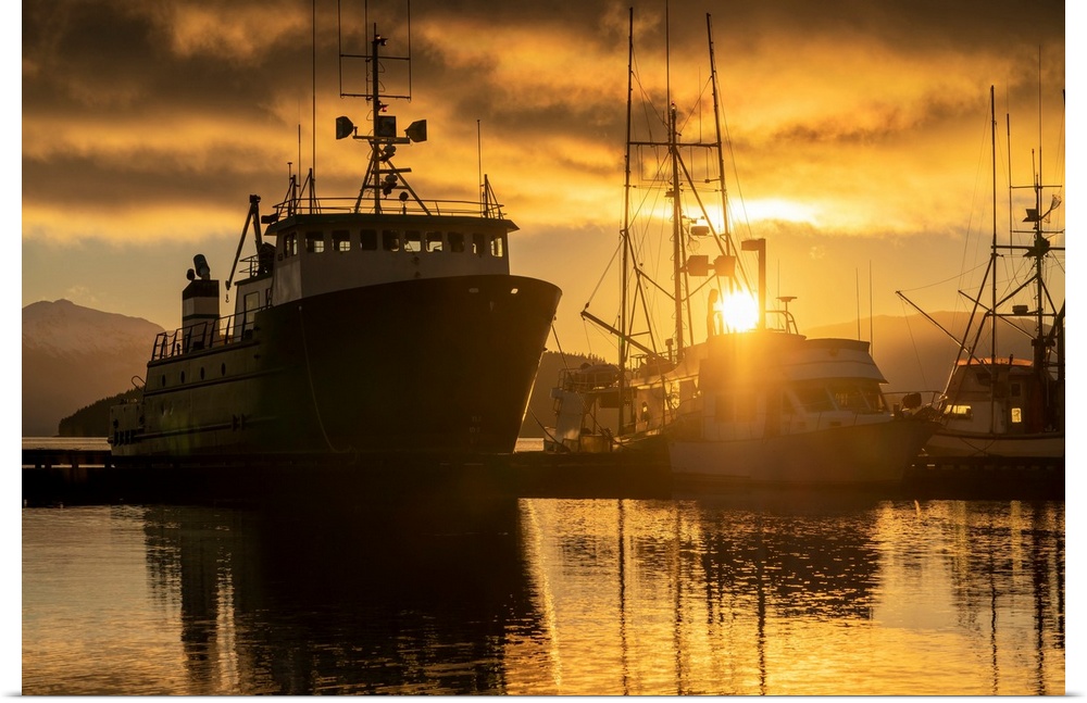 Commercial fishing boats in Auke Bay at sunset, Southeast Alaska; Juneau, Alaska, United States of America.