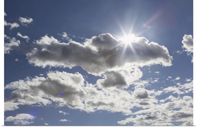 Cumulus Clouds In A Blue Sky With Sunlight Bursting Behind, Edmonton, Alberta, Canada