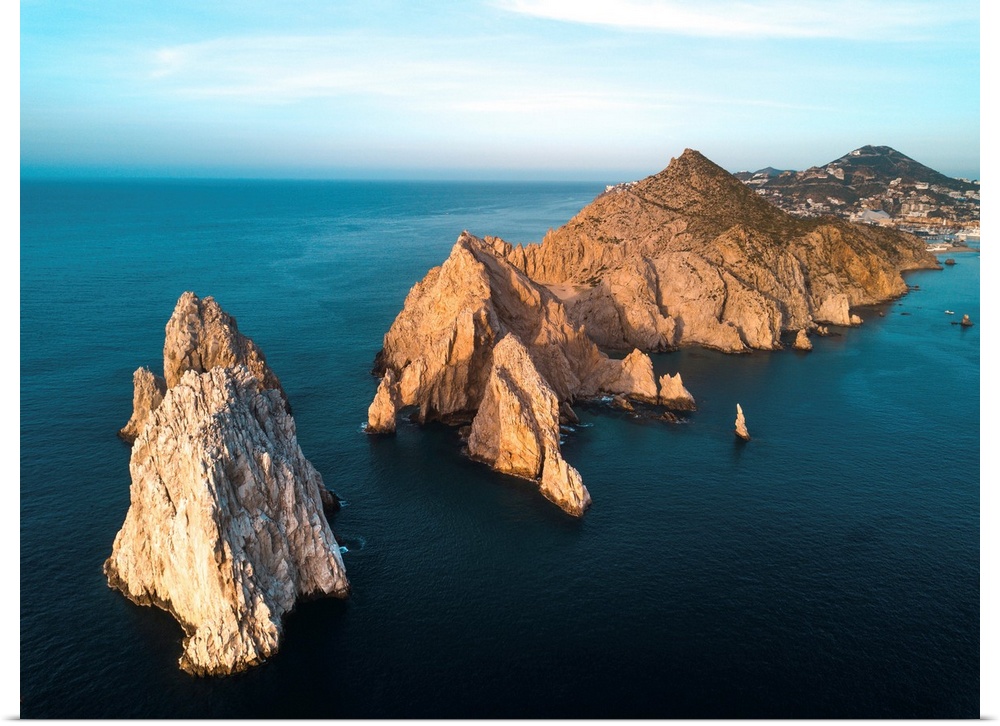 Dramatic rock formations on the southern tip of the Baja Peninsula called Lands End from the air at sunset with the resort...