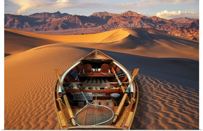 Drift boat resting on sand dunes in Death Valley National Park