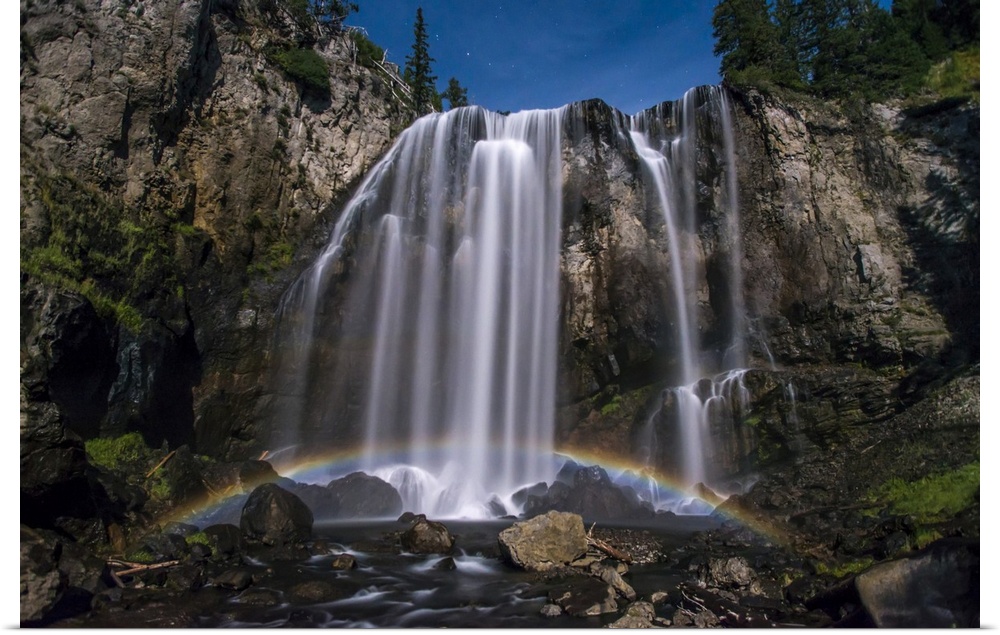 Stunning, Dunanda Falls at night with a lunar rainbow along the Boundary Creek Trail in Yellowstone National Park Wyoming,...