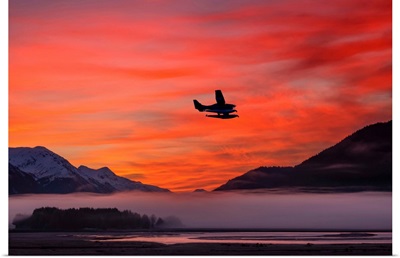 Floatplane takes off from Juneau as the fog begins to clear at sunrise, Southeast Alaska