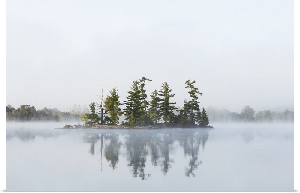 Fog shrouds a small island on Turtle Lake in Ontarios Muskoka Region, near Rosseau; Ontario, Canada