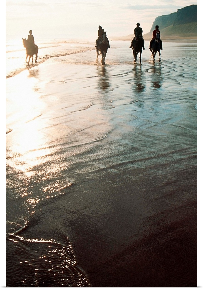 Four People Horseback Riding On A Coastal Beach, Ireland