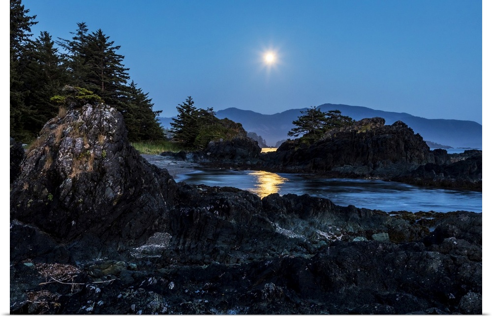 A full moon rises over Nootka Island, Nuchatlitz Provincial Park; British Columbia, Canada