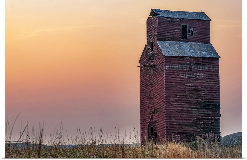 Abandoned and weathered grain elevator at sunset on the Canadian Prairies; Val Marie, Saskatchewan, Canada