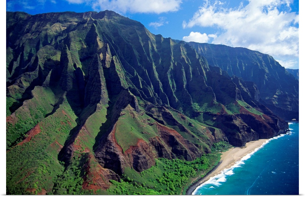 This large piece is an aerial photograph of huge mountains on the coast of a Hawaiian island.
