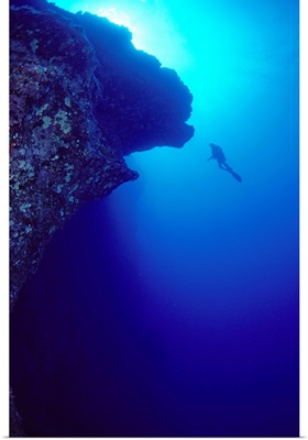 Hawaii, Maui, Molokini, Diver In Distance Alongside Black Wall