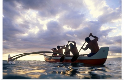 Hawaii, Men On Outrigger Canoe Paddle Into Sunset Under Dramatic Clouds
