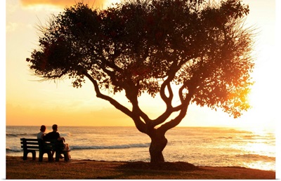 Hawaii, Oahu, Beautiful Sunset Over The Ocean With A Couple Sitting On A Bench