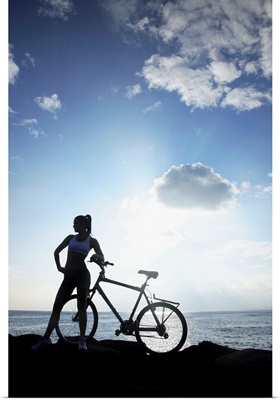 Hawaii, Oahu, Silhouette Of A Woman With A Bike On A Rocky Coastline