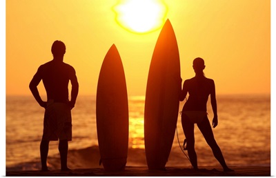 Hawaii, Oahu, Silhouette Of Man And Woman On Beach With Surfboards At Sunset