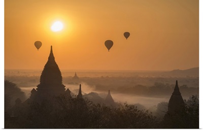 Hot Air Balloons Flying Over Temples On A Misty Morning At Bagan