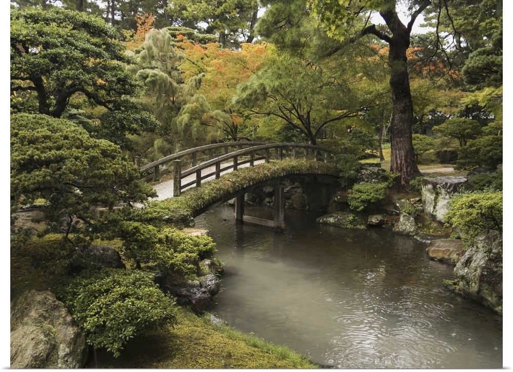 Japanese Stone Bridge Across A Stream In A Park, Kyoto, Japan