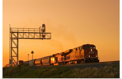 Locomotives Pulling Rail Hopper Cars Pass An Overhead Rail Signal, Alberta, Canada