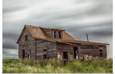 Long exposure of clouds going over an abandoned house, Val Marie, Saskatchewan, Canada
