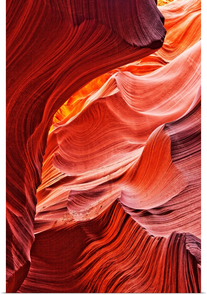 This picture is taken inside of a canyon where the rock has formed into a beautiful curved design.