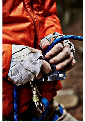 Man adjusting rock climbing equipment in the Adirondacks, New York