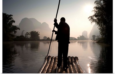 Man On Raft In Mountain Area; Yulong River, Yangshuo, China