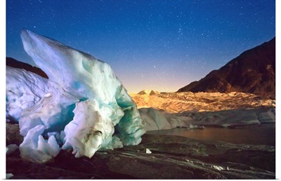 Mendenhall Glacier with a large iceberg and starry sky, Juneau, Southeast Alaska