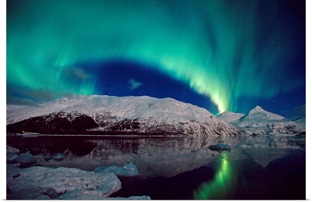 Canvas photo art of northern lights in the sky above snow covered mountains near water.