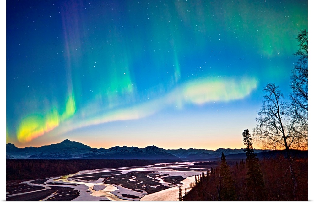 Northern Lights in the sky above Mount McKinley and the Alaska range at twilight with the glow from the  setting sun low o...