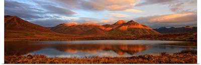 Panoramic Of Sunrise Over Mount Adney Reflected In A Pond In Fall, Yukon, Canada