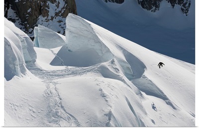 Professional snowboarder jumps off a glacier, New Zealand
