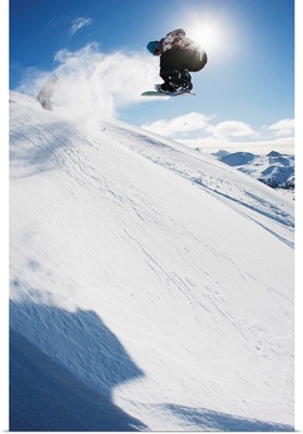 Professional snowboarder making a jump in fresh snow near Ushuaia, Patagonia, Argentina