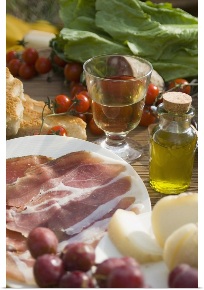 Prosciutto Ham, Cheese, Tomatoes, White Wine And Other Ingredients For A Picnic In Tuscany, Italy