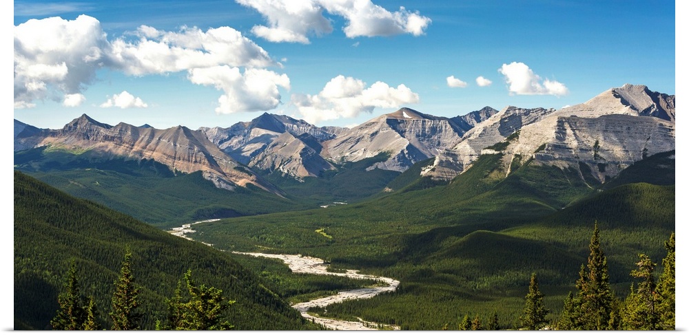Panorama of river valley and mountain range with blue sky and clouds, Bragg Creek, Alberta, Canada.