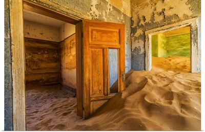 Sand in the rooms of a colourful and abandoned house, Kolmanskop, Namibia