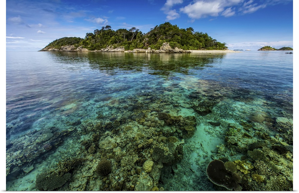 Scenic seascape of coral surrounding a tropical island.
