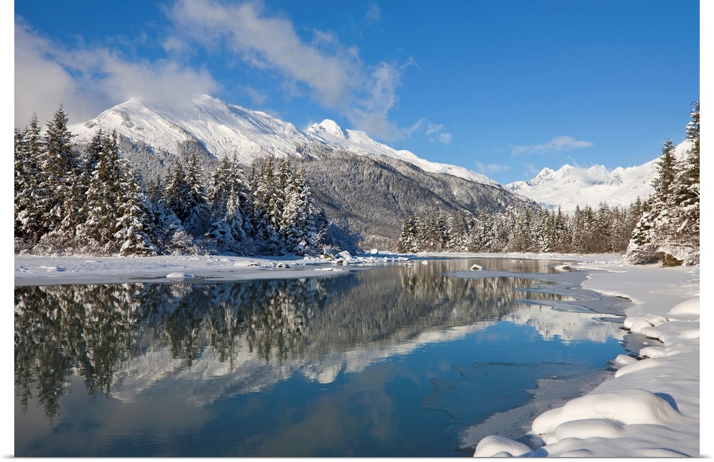 A snowy winter wonderland awaits along the Mendenhall River, Mendenhall Glacier and Towers in the distance, Tongass Forest...