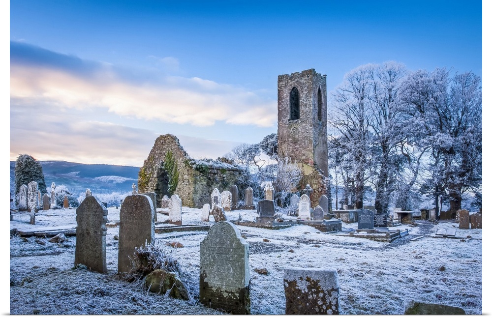 Shanrahan Church, an old church ruins and graveyard covered in snow at sunrise; Adrfinnan, County Tipperary, Ireland.