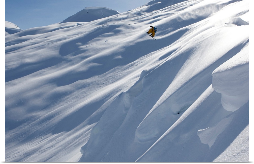 Professional snowboarder, Frederik Kalbermatten, heli boarding in the mountains above Haines, Alaska.