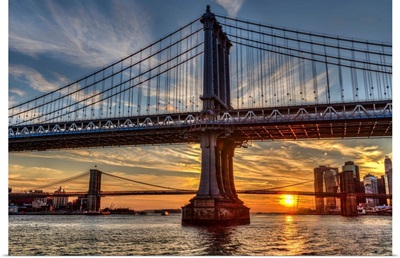 Sun setting behind Manhattan and Brooklyn Bridges; New York City