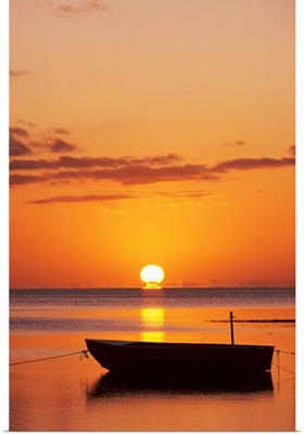 Sun Setting Over Ocean, Boat Silhouetted Against Orange Sky