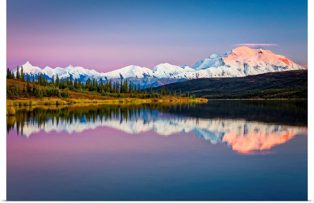 Sunset glow on Mount Denali (McKinley) reflects on Wonder Lake with pastel sky, Denali National Park and Preserve in autum...