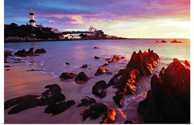 Sunset Over Beach With Lighthouse